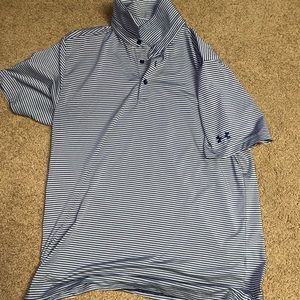 Under armour golf. Has a golf course logo on the sleeve.